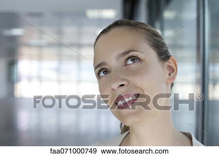 Woman looking up with head tilted View Large Photo Image Stock Photo - Woman looking up with head tilted. Fotosearch