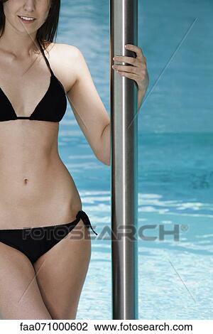 Woman on swimming pool ladder getting out of the water View Large Photo Image Stock Image - Woman on swimming pool ladder getting out of the water. Fotosearch
