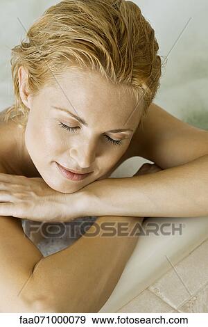 Stock Photo - Woman relaxing in bath. Fotosearch