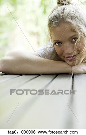 Stock Photograph - Woman resting head on table, portrait. Fotosearch
