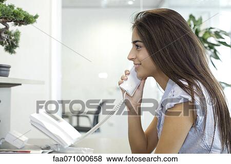 Woman talking on landline telephone View Large Photo Image Stock Photo - Woman talking on landline telephone. Fotosearch