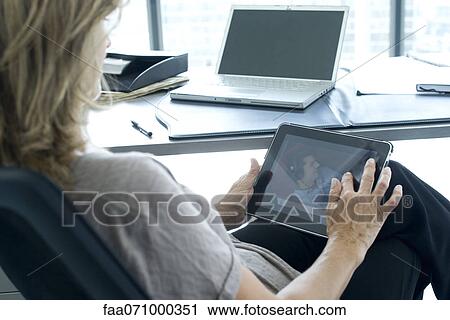 Woman using digital tablet View Large Photo Image Stock Image - Woman using digital tablet. Fotosearch