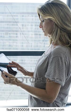 Woman using digital tablet View Large Photo Image Stock Photo - Woman using digital tablet. Fotosearch
