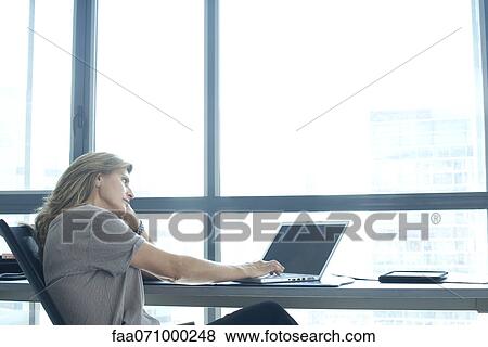 Stock Photo - Woman using laptop. Fotosearch