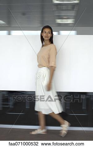 Woman walking in office, blurred motion View Large Photo Image Stock Image - Woman walking in office, blurred motion. Fotosearch