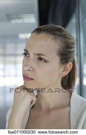 Stock Image - Woman with confused expression. Fotosearch