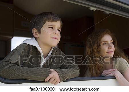 Young boy and mother looking out motor home window View Large Photo Image Stock Image - Young boy and mother looking out motor home window. Fotosearch