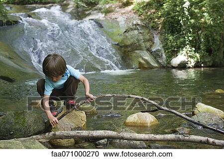 Young boy exploring nature View Large Photo Image Stock Image - Young boy exploring nature. Fotosearch