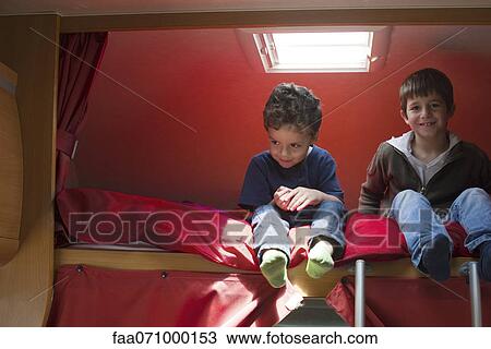 Young brothers sitting on bed in motor home View Large Photo Image Stock Image - Young brothers sitting on bed in motor home. Fotosearch
