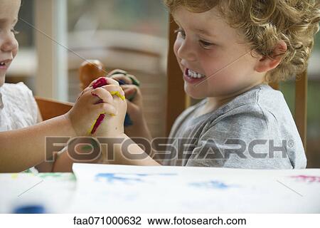 Young children holding hands while finger painting View Large Photo Image Stock Image - Young children holding hands while finger painting. Fotosearch