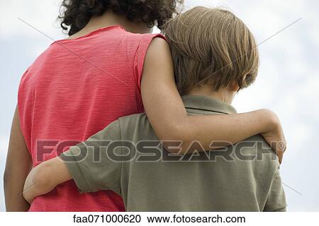 Young siblings embracing, rear view View Large Photo Image Stock Image - Young siblings embracing, rear view. Fotosearch