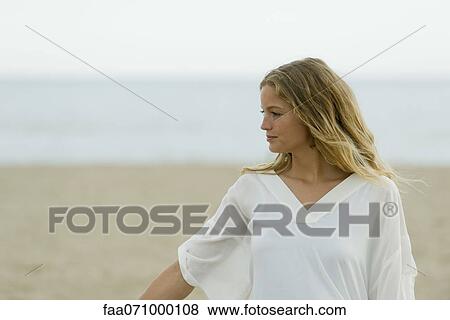 Young woman at the beach View Large Photo Image Stock Photo - Young woman at the beach. Fotosearch