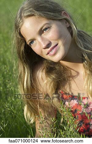 Young woman daydreaming outdoors, portrait View Large Photo Image Picture - Young woman daydreaming outdoors, portrait. Fotosearch
