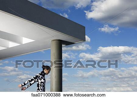 Young woman pressing forehead against portico column View Large Photo Image Stock Photo - Young woman pressing forehead against portico column. Fotosearch