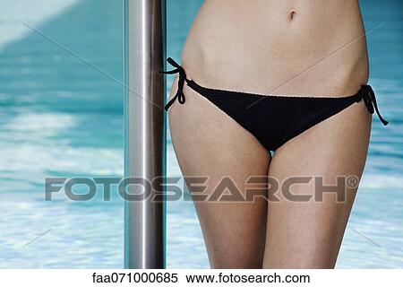 Young woman wearing bikini, cropped View Large Photo Image Stock Photography - Young woman wearing bikini, cropped. Fotosearch