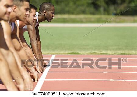 Athletes at starting line, focus on one man View Large Photo Image Stock Image - Athletes at starting line, focus on one man. Fotosearch