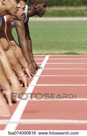 Athletes at starting line View Large Photo Image Stock Photograph - Athletes at starting line. Fotosearch