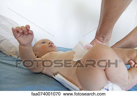 Baby having diaper changed, cropped View Large Photo Image Stock Image - Baby having diaper changed, cropped. Fotosearch