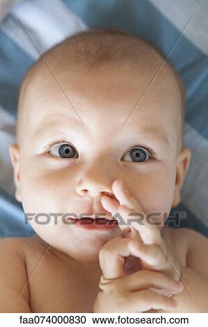 Stock Image - Baby looking up, portrait. Fotosearch