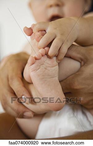 Baby touching its toes, cropped View Large Photo Image Stock Image - Baby touching its toes, cropped. Fotosearch