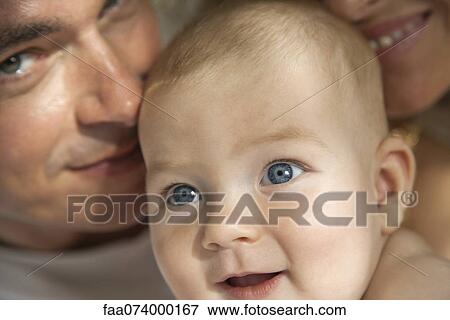 Baby with parents, cropped portrait View Large Photo Image Stock Photo - Baby with parents, cropped portrait. Fotosearch