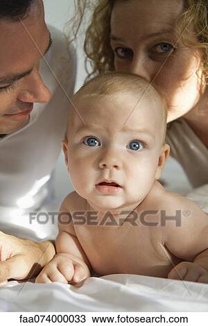 Stock Image - Baby with parents, portrait. Fotosearch