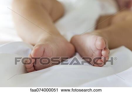 Stock Image - Baby's bare feet. Fotosearch