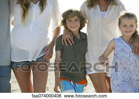 Boy and girl walking with family at the beach View Large Photo Image Stock Photograph - Boy and girl walking with family at the beach. Fotosearch