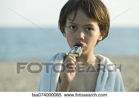 Boy eating popsicle, portrait View Large Photo Image Stock Photography - Boy eating popsicle, portrait. Fotosearch
