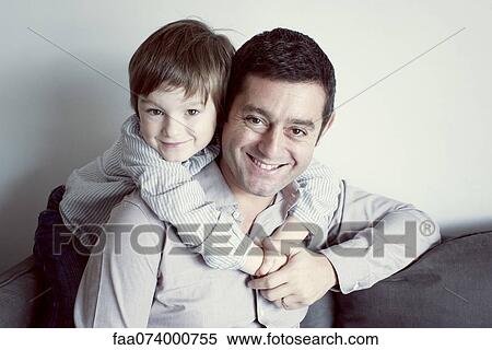 Boy embracing his father, portrait View Large Photo Image Stock Photography - Boy embracing his father, portrait. Fotosearch