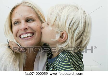 Stock Photo - Boy kissing his mother on the cheek. Fotosearch