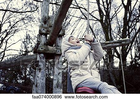 Boy playing on swing View Large Photo Image Stock Photograph - Boy playing on swing. Fotosearch