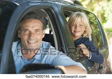 Boy riding in car with father, leaning out window and smiling at camera View Large Photo Image Stock Photography - Boy riding in car with father, leaning out window and smiling at camera. Fotosearch