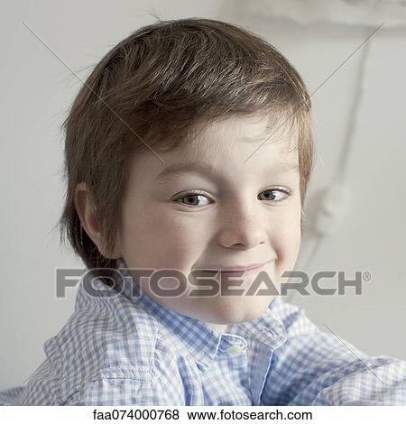 Boy smiling over shoulder, portrait View Large Photo Image Stock Photo - Boy smiling over shoulder, portrait. Fotosearch