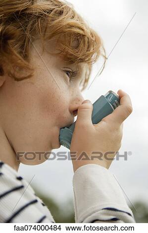 Boy using asthma inhaler View Large Photo Image Picture - Boy using asthma inhaler. Fotosearch