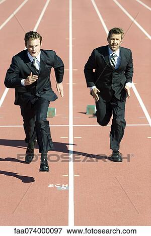 Businessmen racing each other on running track View Large Photo Image Stock Photo - Businessmen racing each other on running track. Fotosearch