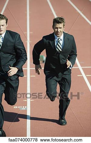 Stock Photo - Businessmen racing each other on running track. Fotosearch
