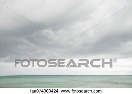 Picture - Cloudy sky over ocean. Fotosearch