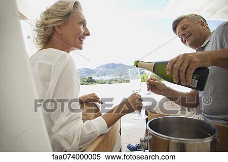 Couple enjoying champagne outdoors View Large Photo Image Stock Photography - Couple enjoying champagne outdoors. Fotosearch