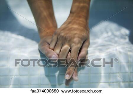 Couple holding hands underwater, cropped View Large Photo Image Stock Image - Couple holding hands underwater, cropped. Fotosearch