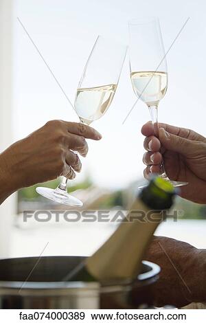 Couple toasting with champagne, cropped View Large Photo Image Stock Photo - Couple toasting with champagne, cropped. Fotosearch