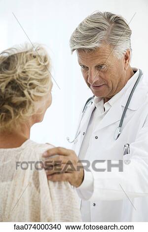 Doctor comforting patient View Large Photo Image Stock Image - Doctor comforting patient. Fotosearch