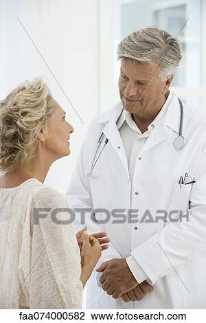 Doctor talking with patient View Large Photo Image Stock Image - Doctor talking with patient. Fotosearch