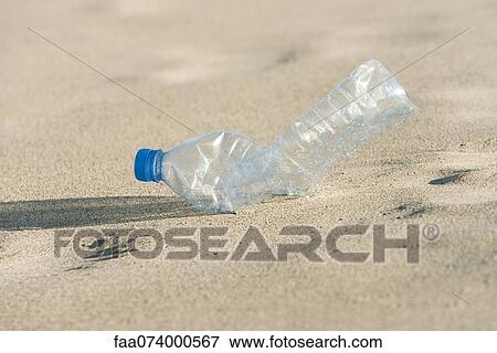 Empty plastic bottle on beach, close-up View Large Photo Image Stock Photo - Empty plastic bottle on beach, close-up. Fotosearch