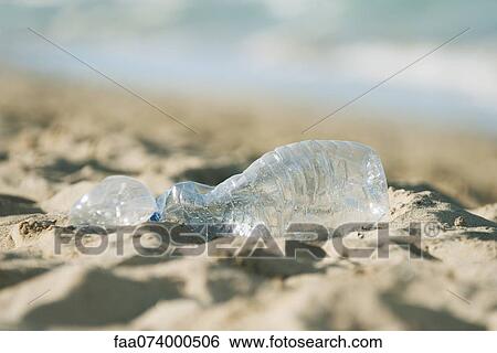 Empty plastic bottle on beach, selective focus View Large Photo Image Stock Photograph - Empty plastic bottle on beach, selective focus. Fotosearch