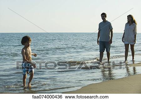 Family at the beach together View Large Photo Image Stock Photograph - Family at the beach together. Fotosearch