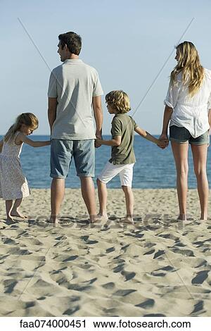 Family holding hands at the beach View Large Photo Image Stock Image - Family holding hands at the beach. Fotosearch