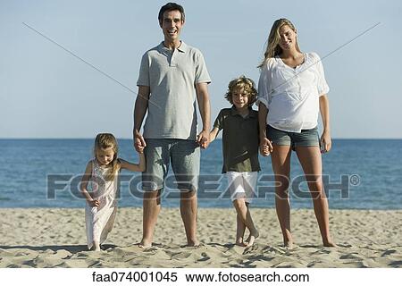 Family holding hands at the beach View Large Photo Image Stock Photography - Family holding hands at the beach. Fotosearch