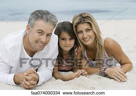 Family lying on beach, portrait View Large Photo Image Picture - Family lying on beach, portrait. Fotosearch