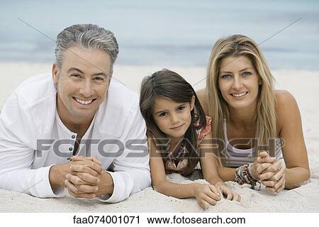 Family lying on beach, portrait View Large Photo Image Stock Image - Family lying on beach, portrait. Fotosearch